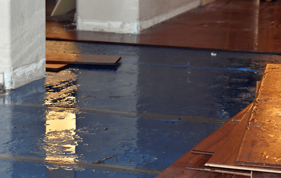 Home with floor boards pulled up due to water damage